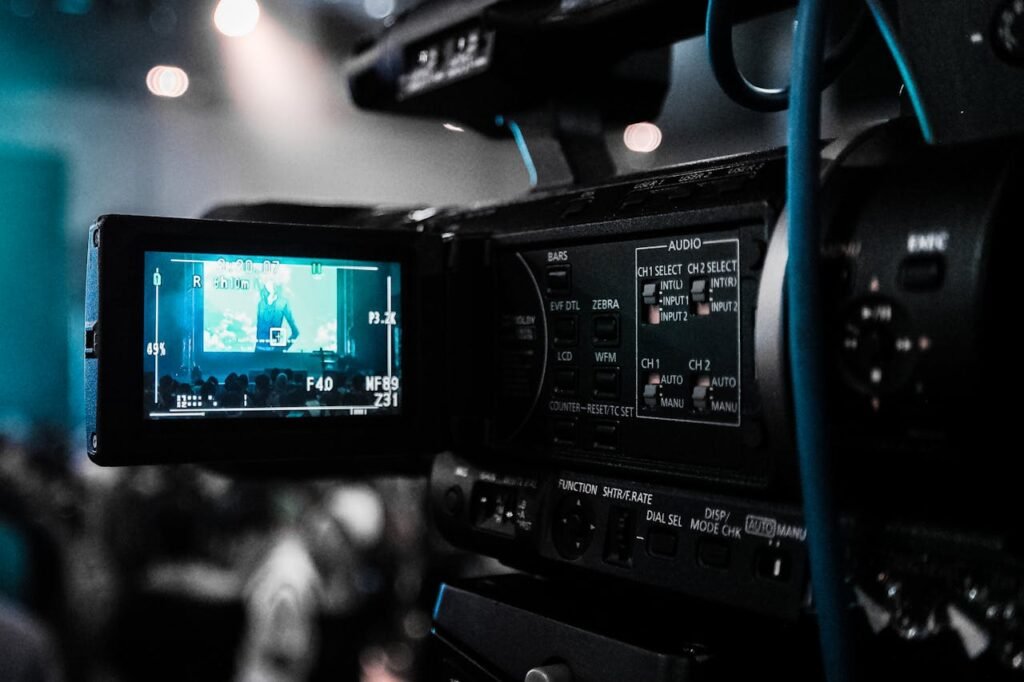HOME HD video camera capturing a live event; focus on screen and controls.