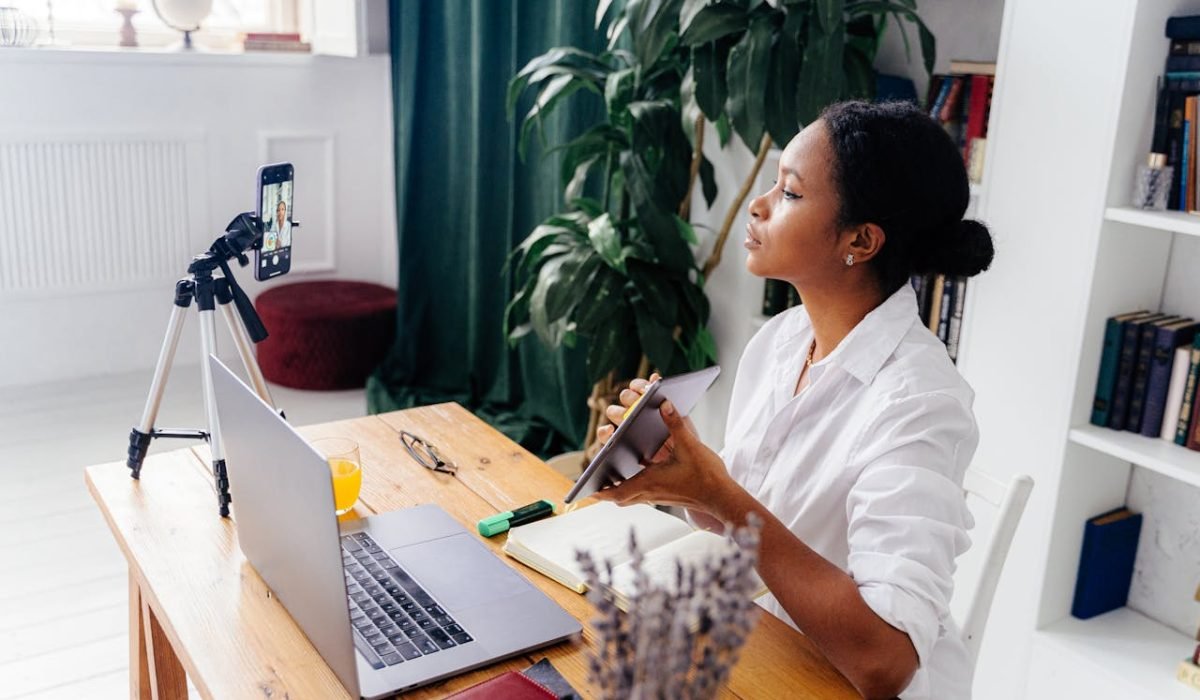 pexels photo 6266975 Black woman using electronic devices for vlogging indoors at home office.